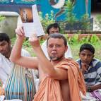 Giri Maharaja Showing the Devotees the Book