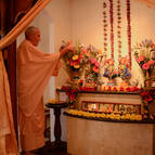 Guru Maharaja offering arati to the Deities